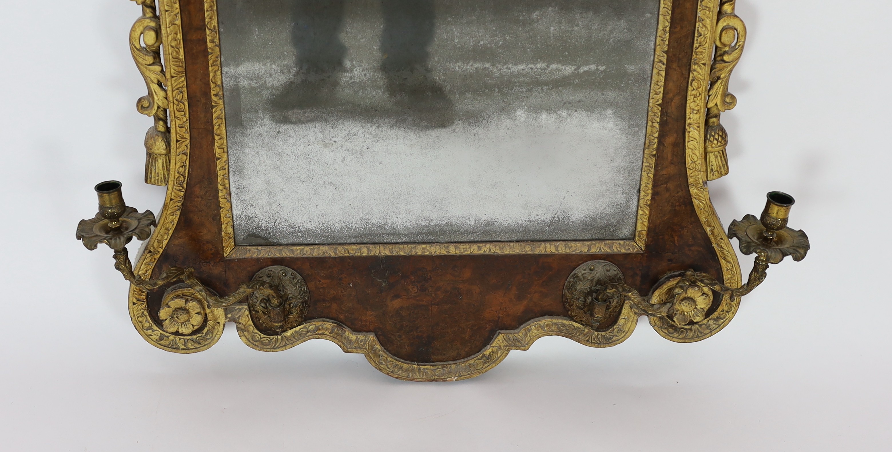 A George II and later carved giltwood and burr walnut wall mirror, 133.5cm high, 69cm wide